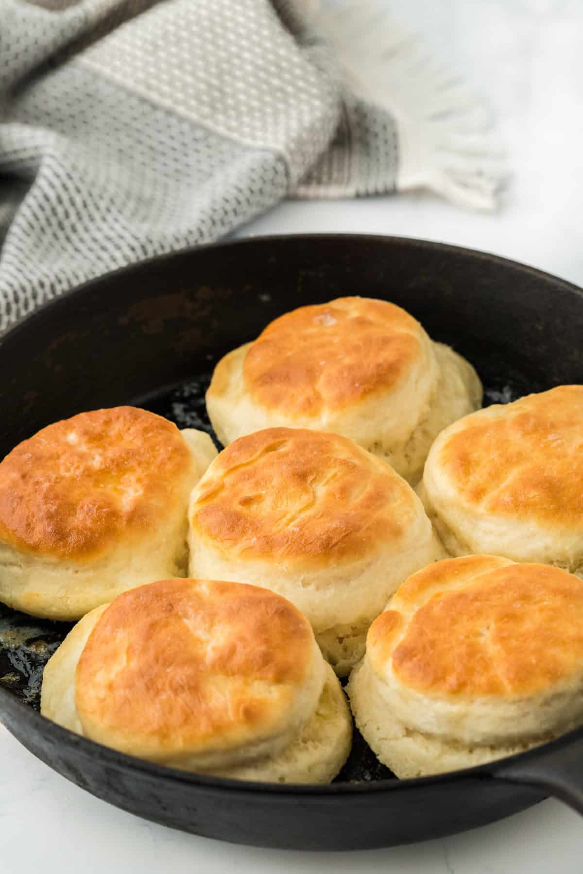 Baked 7up biscuit recipe in a cast iron skillet on white countertop