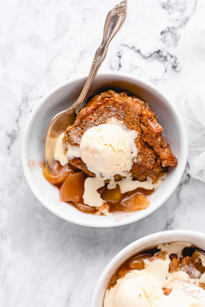 A large bowl of apple cobbler with vanilla ice cream