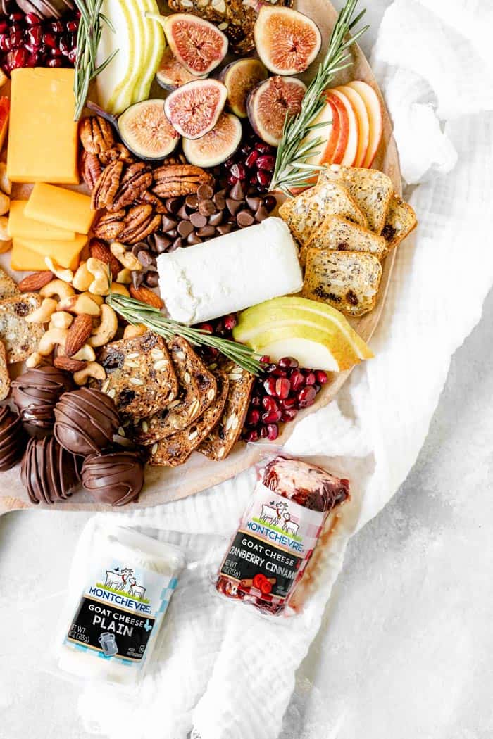 A close up of holiday winter dessert board with goat cheese packages