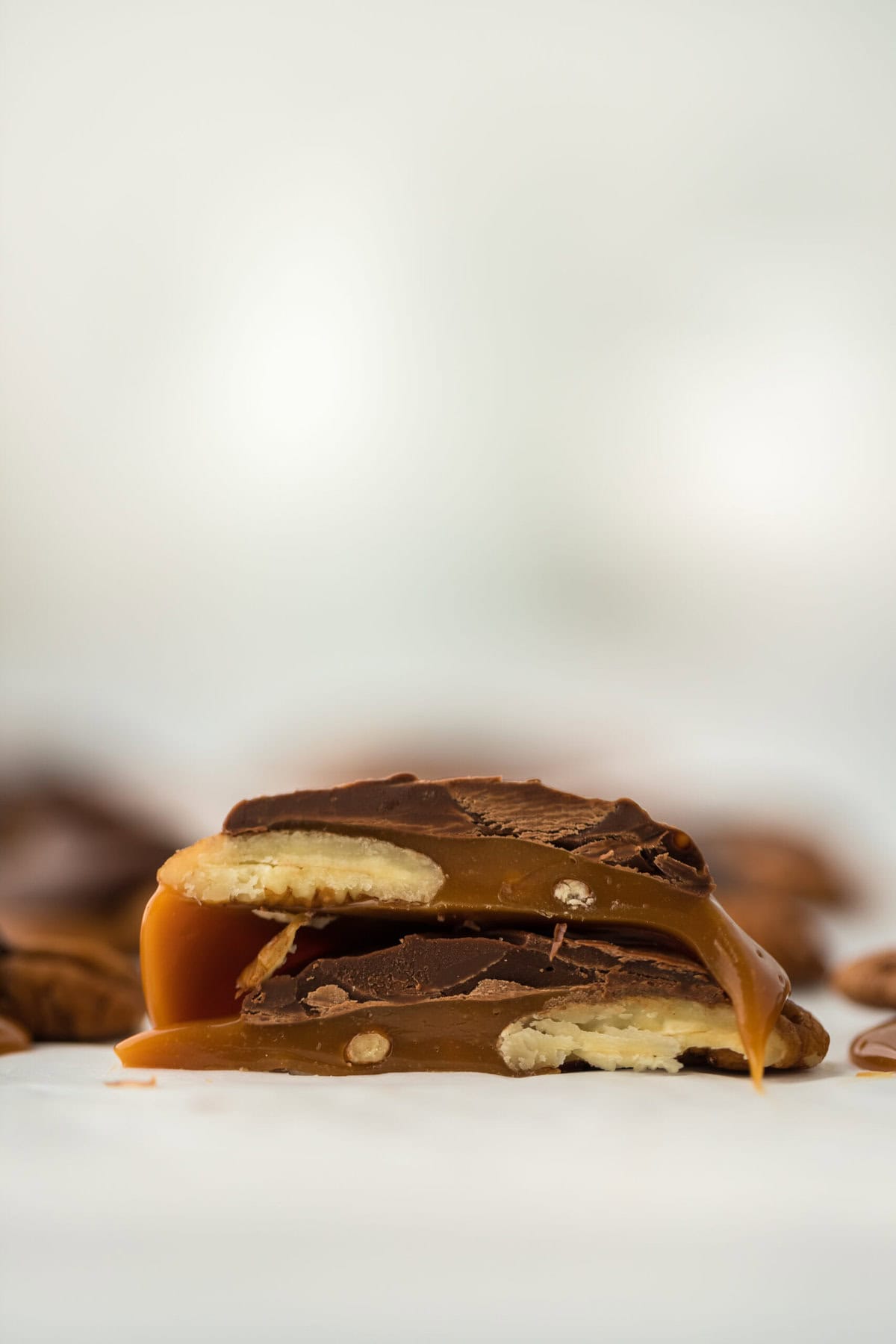 Turtle candies cut in half on white countertop