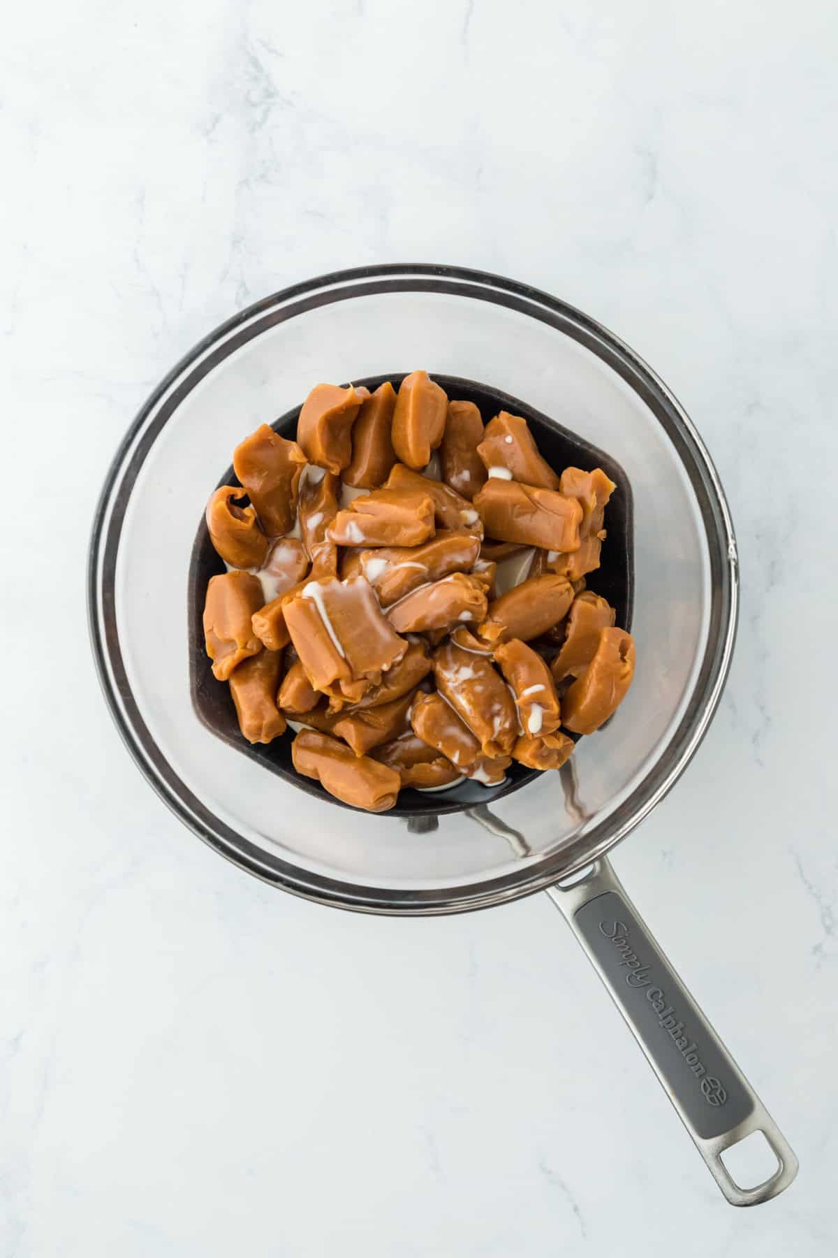 Caramels and milk in a double boiler