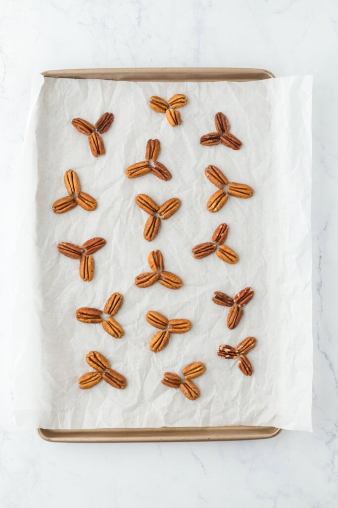 Nuts positioned in groupings on parchment paper