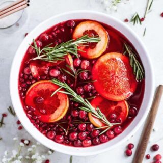 Best christmas punch served in a punch bowl with floating fruit.