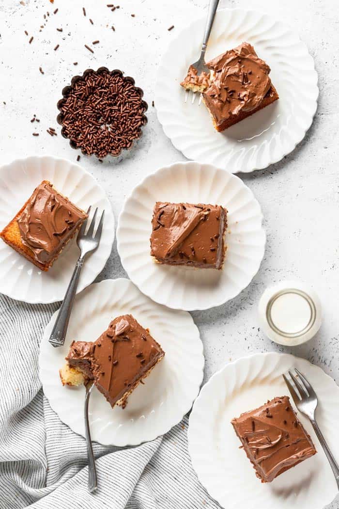 Sheet cake slices on white plates with silver forks ready to serve after using baking tips