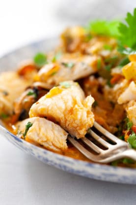 A fork of tender fish from brazilian fish stew ready to eat