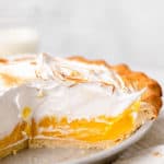 A close up of cut open lemon pie with torched meringue topping
