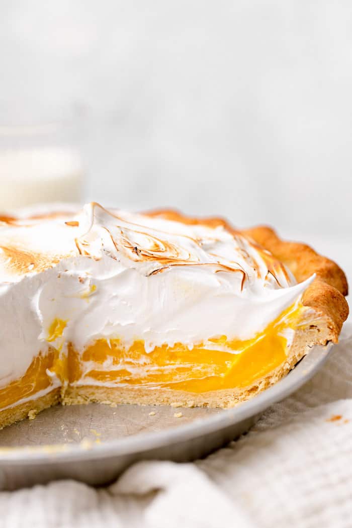 A close up of cut open lemon pie with torched meringue topping