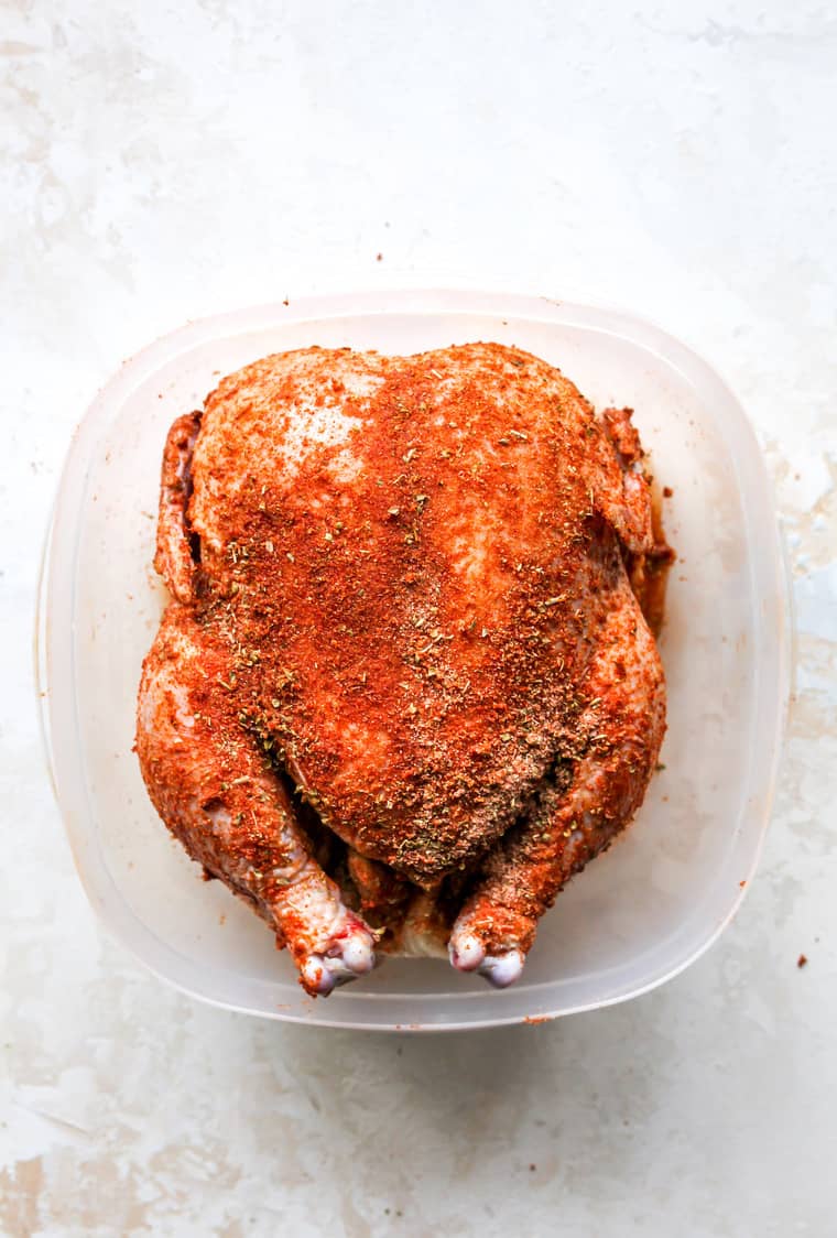 Spices rubbed on a chicken before baking