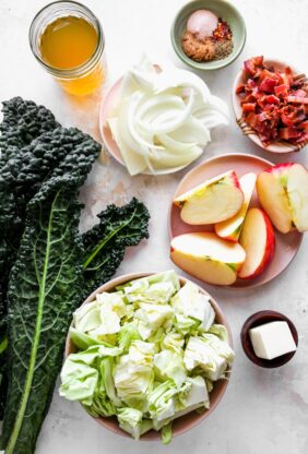 Kale, apple, cabbage, onions and other ingredients for a cabbage recipe