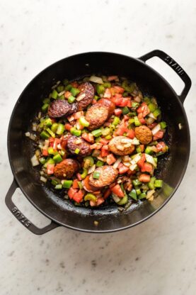 A delicious skillet of sauteed sausage, onion, pepeprs and tomatoes