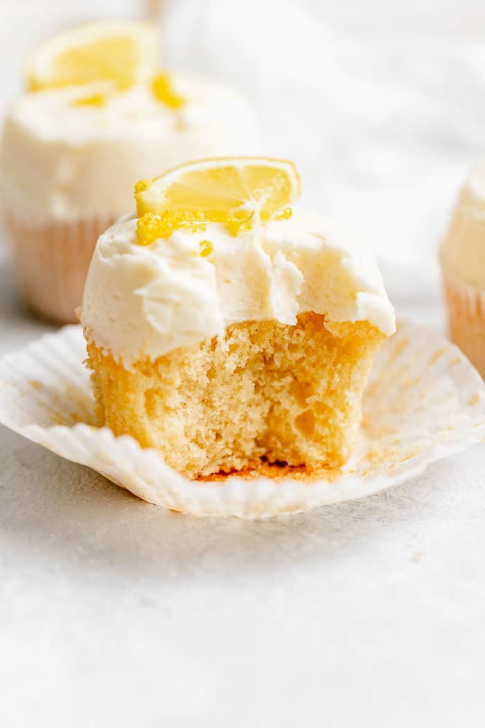 A close up of the best lemon cupcakes with one missing a big bite