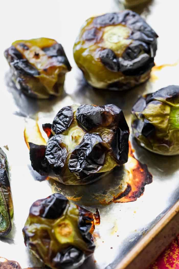 Tomatillos on a baking sheet after being roasted