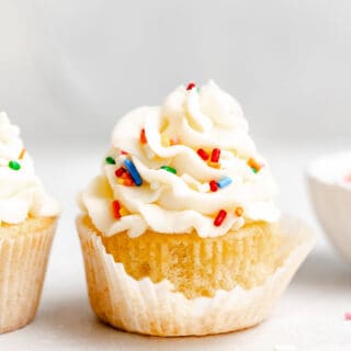 A cupcake with a liner beginning to come off