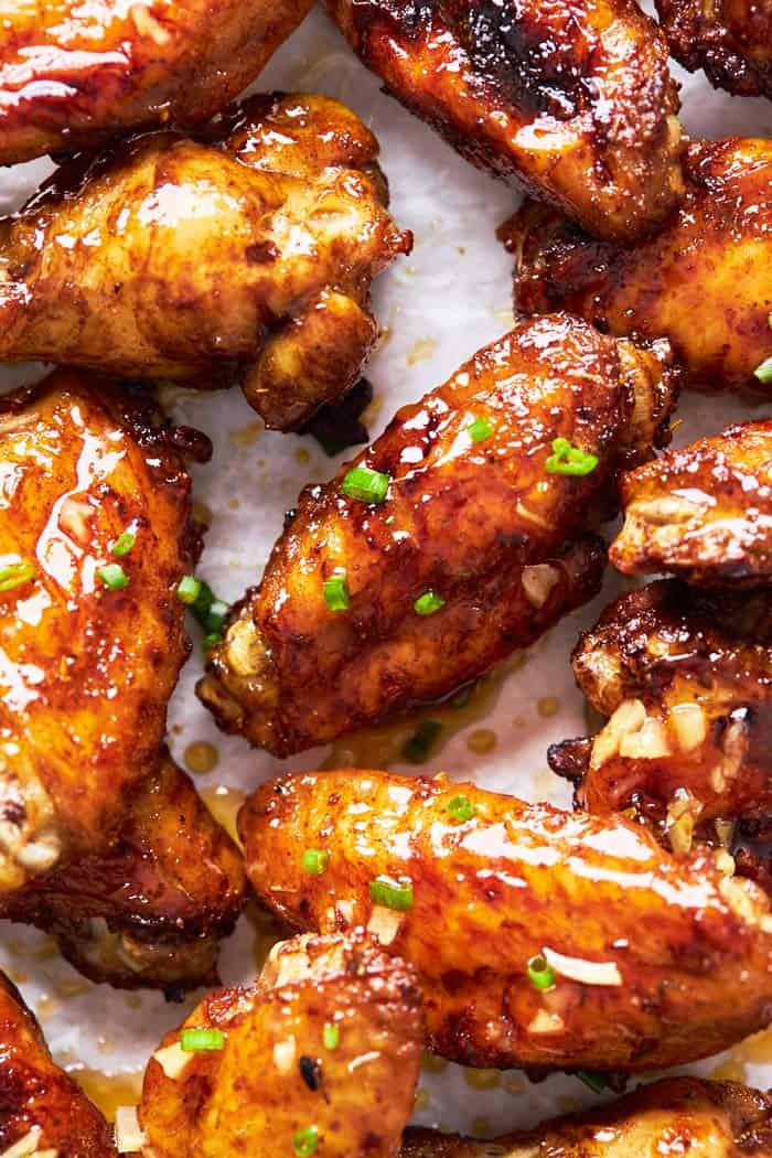A close up of honey garlic jerk wings ready to serve