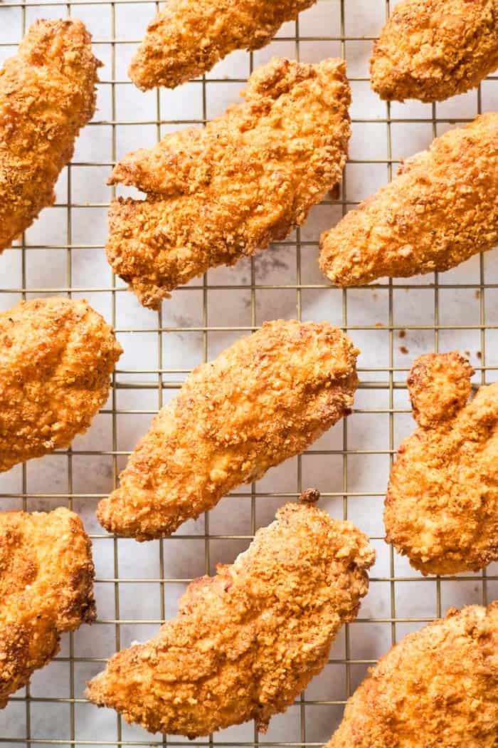 Crispy chicken tenders after being air fried on a wire rack