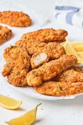 A close up of keto fried chicken on a white plate