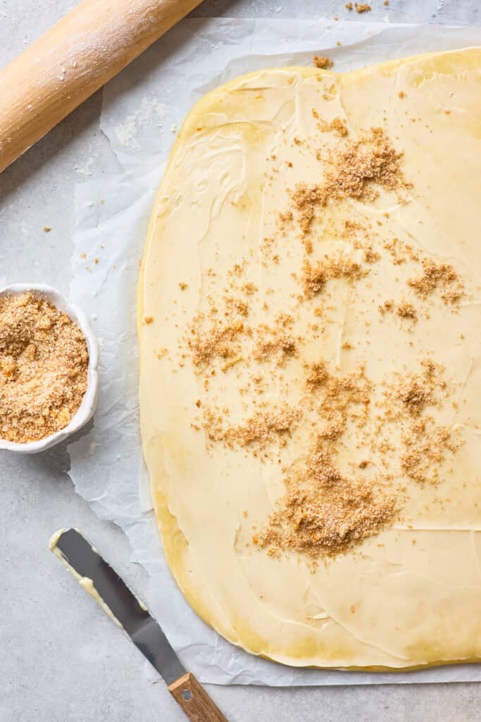 Cinnamon roll dough sprinkled with brown sugar