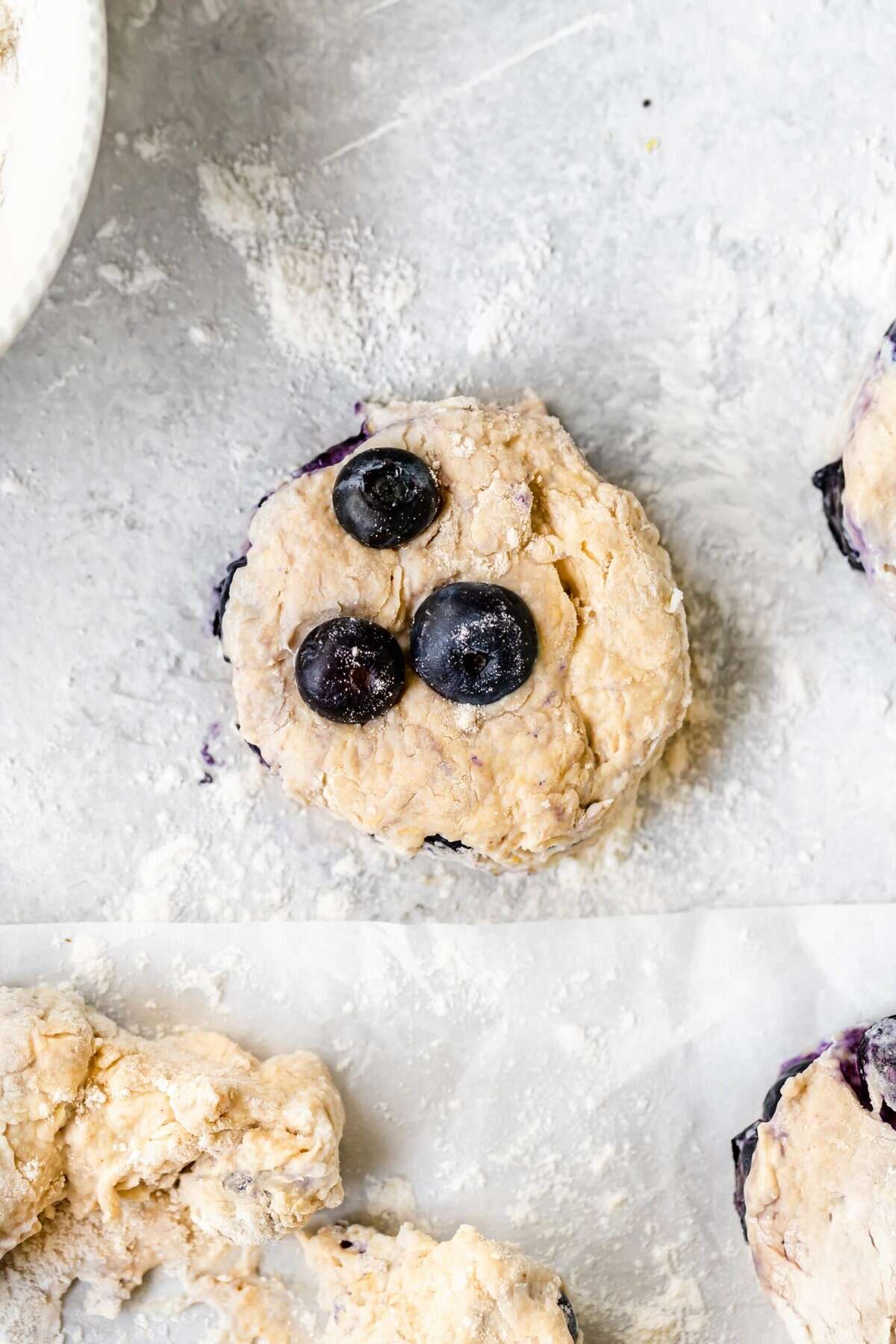 A close up of a lemon blueberry biscuit on a countertop