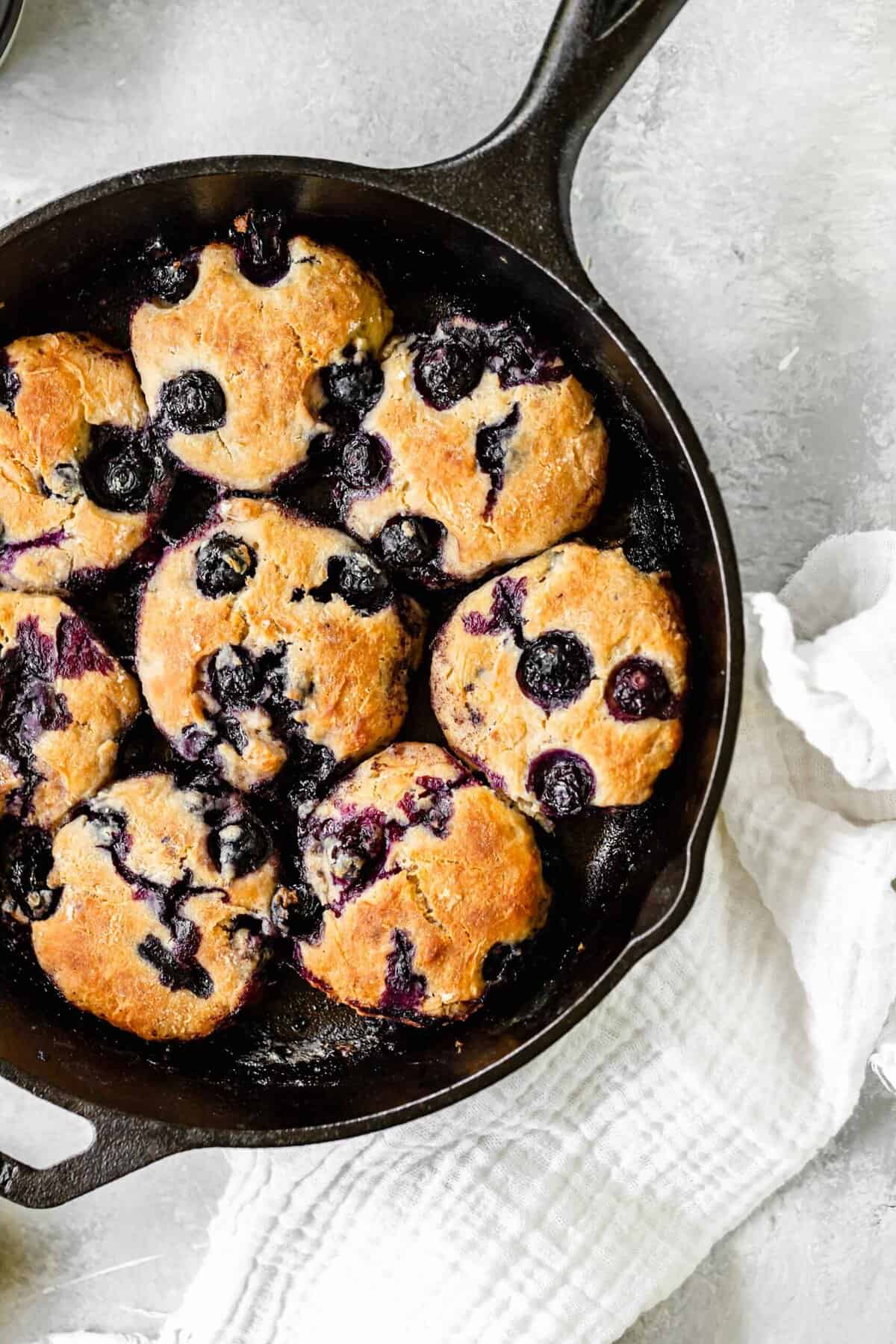 Close up of lemon biscuits with blueberries in cast iron skillet