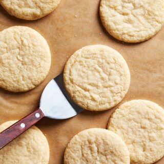 Lemon tea cakes being served from a baking sheet after baking