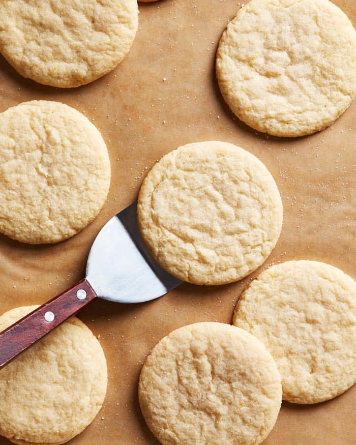 Lemon tea cakes being served from a baking sheet after baking