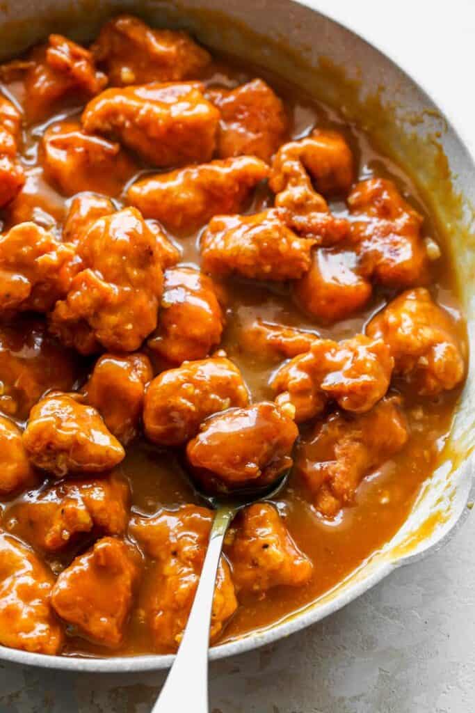 Fried chicken pieces in a thick Asian orange sauce
