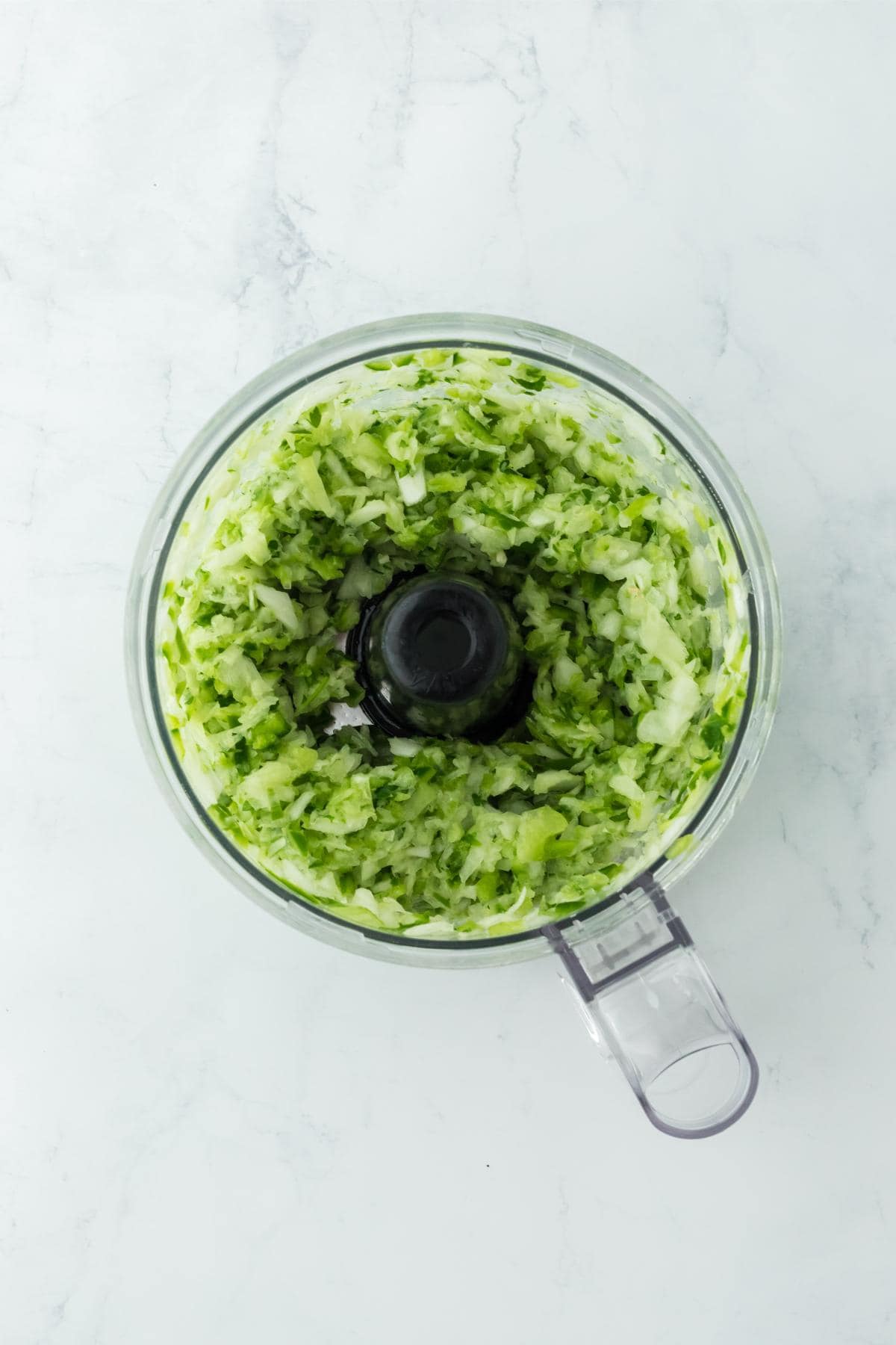 Finely chopped vegetables inside the food processor bowl