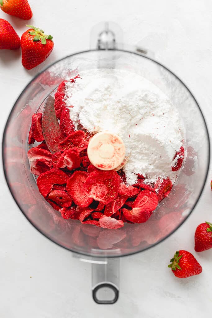 Strawberries and powdered sugar in a food processor