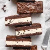 An overhead of brownie ice cream sandwiches against a white background