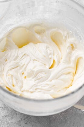 Cream cheese frosting in a mixer bowl after being mixed until smooth