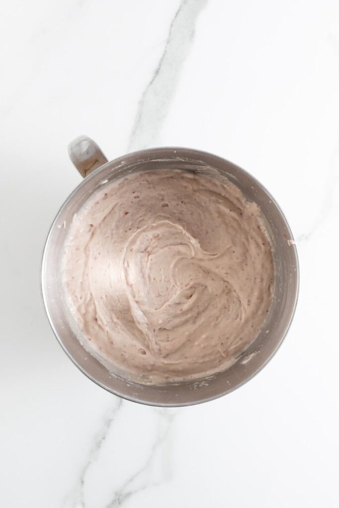 Completed strawberry cupcake recipe batter in a stand mixer bowl