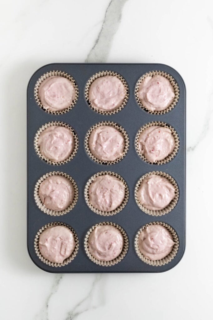 strawberry cupcake batter in muffin tins before baking