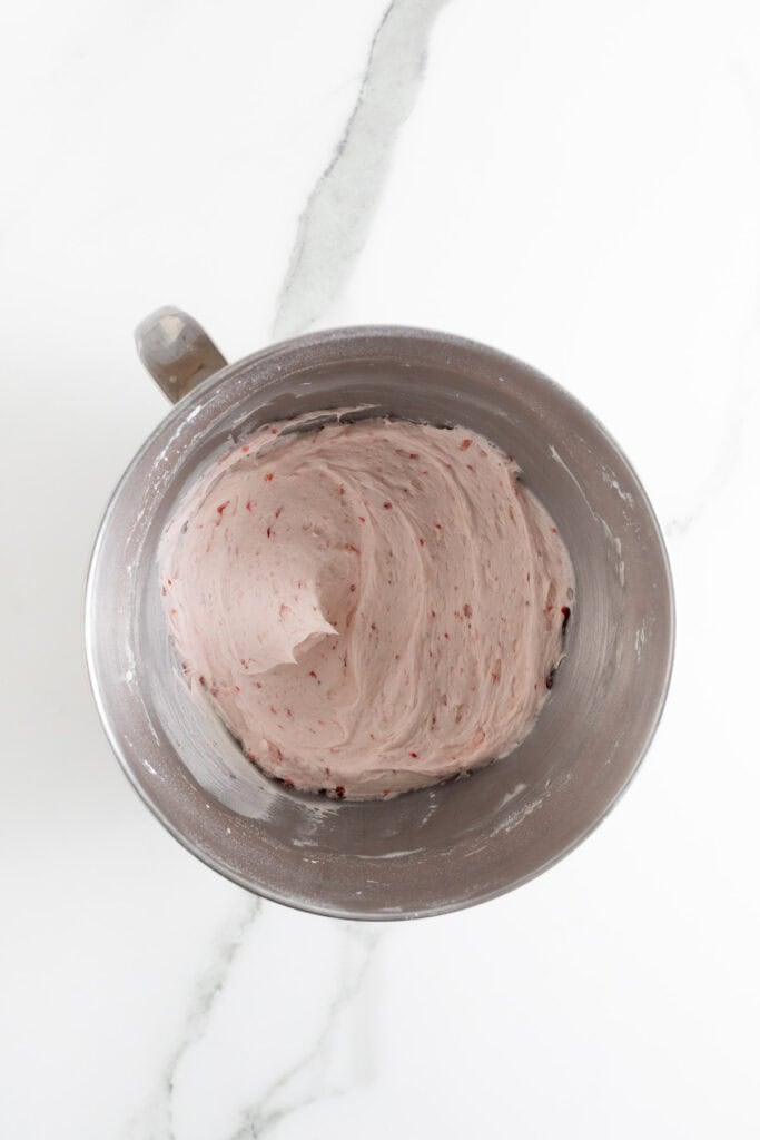 Completed strawberry buttercream for strawberry cupcakes in a mixing bowl
