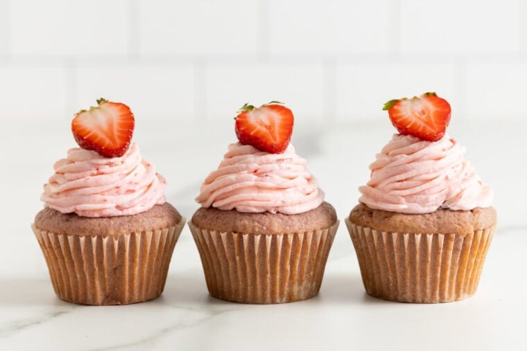 Three strawberry cupcakes lined up