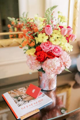 A floral arrangement on desk in hotel room