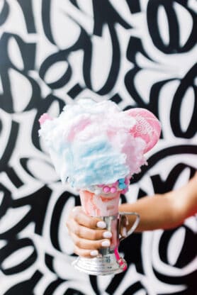 Jocelyn Delk Adams holding a cotton candy crazyshake at The Venetian Black Tap restaurant