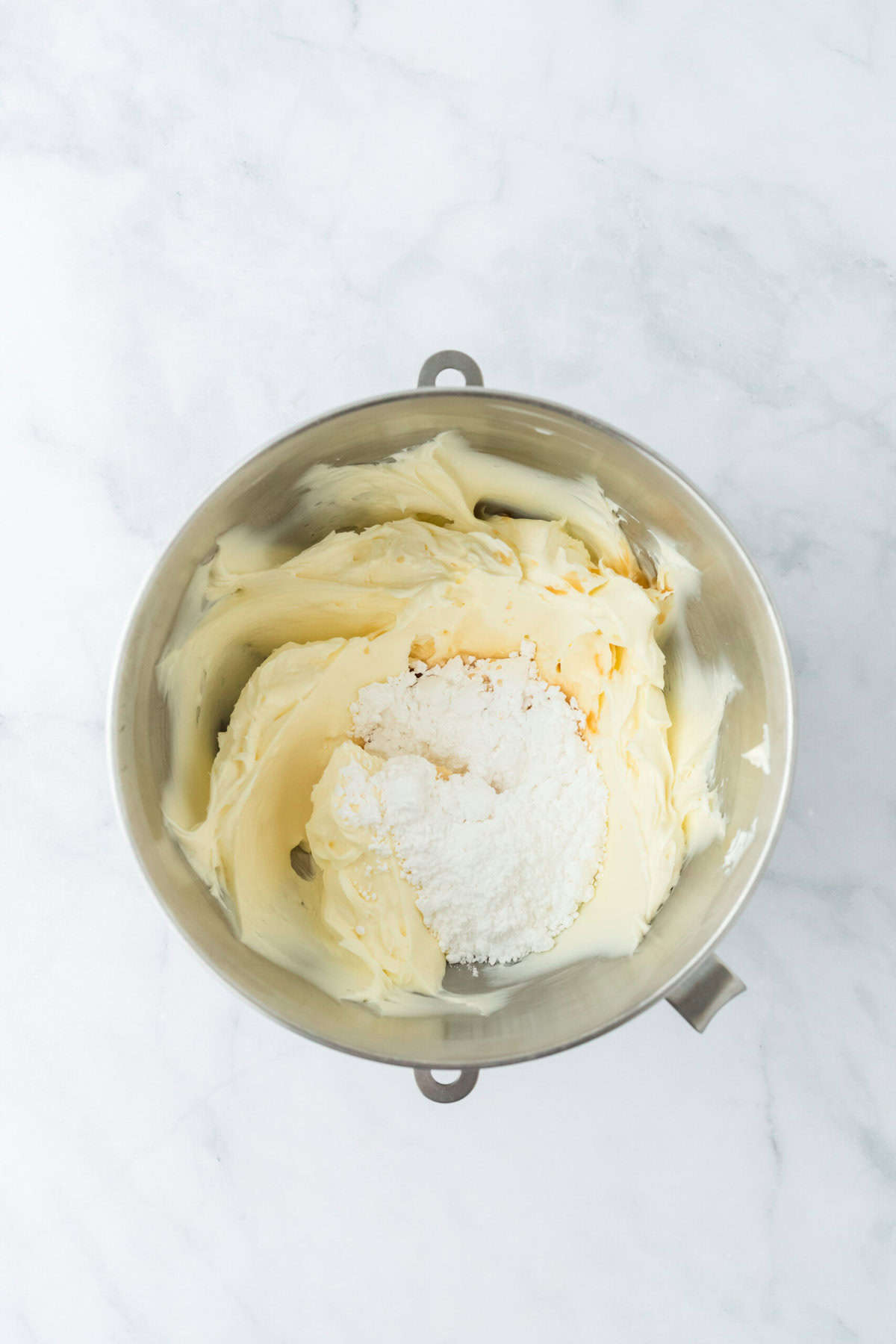 Confectioner's sugar added to stand mixer to make cream cheese frosting