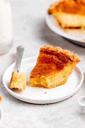 a slice of lemon chess pie being eaten with a fork