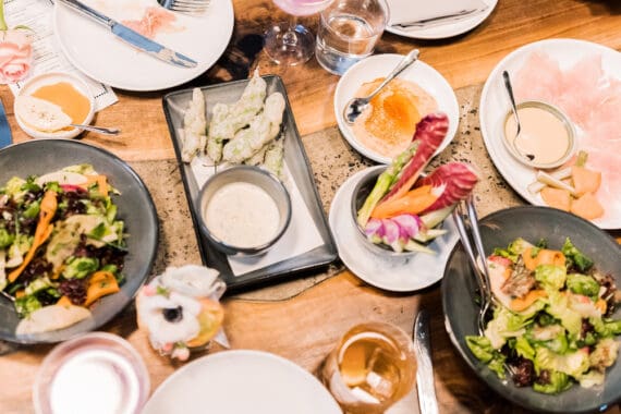 An overhead spread of salad, ham and several appetizers at Majordomo