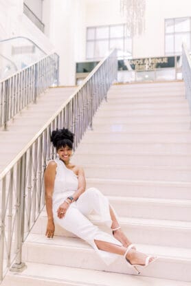 Jocelyn Delk Adams sitting on steps at The Palazzo