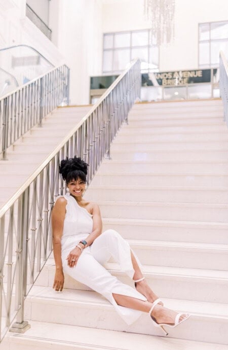 Jocelyn Delk Adams sitting on steps at The Palazzo