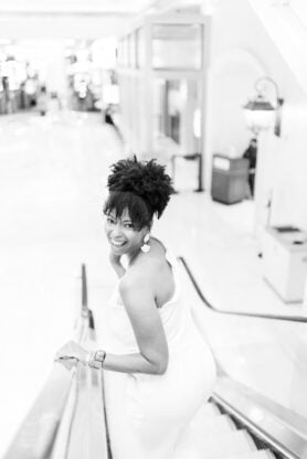 Jocelyn Delk Adams riding down elevator at The Palazzo in Las Vegas in black and white shot