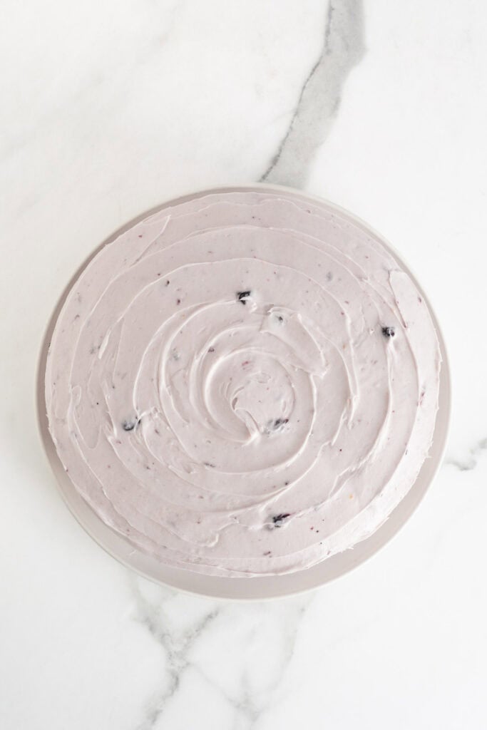 A frosted blueberry lemon cake with swirled frosting