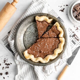 Slices cut from a chocolate chess pie against a white background