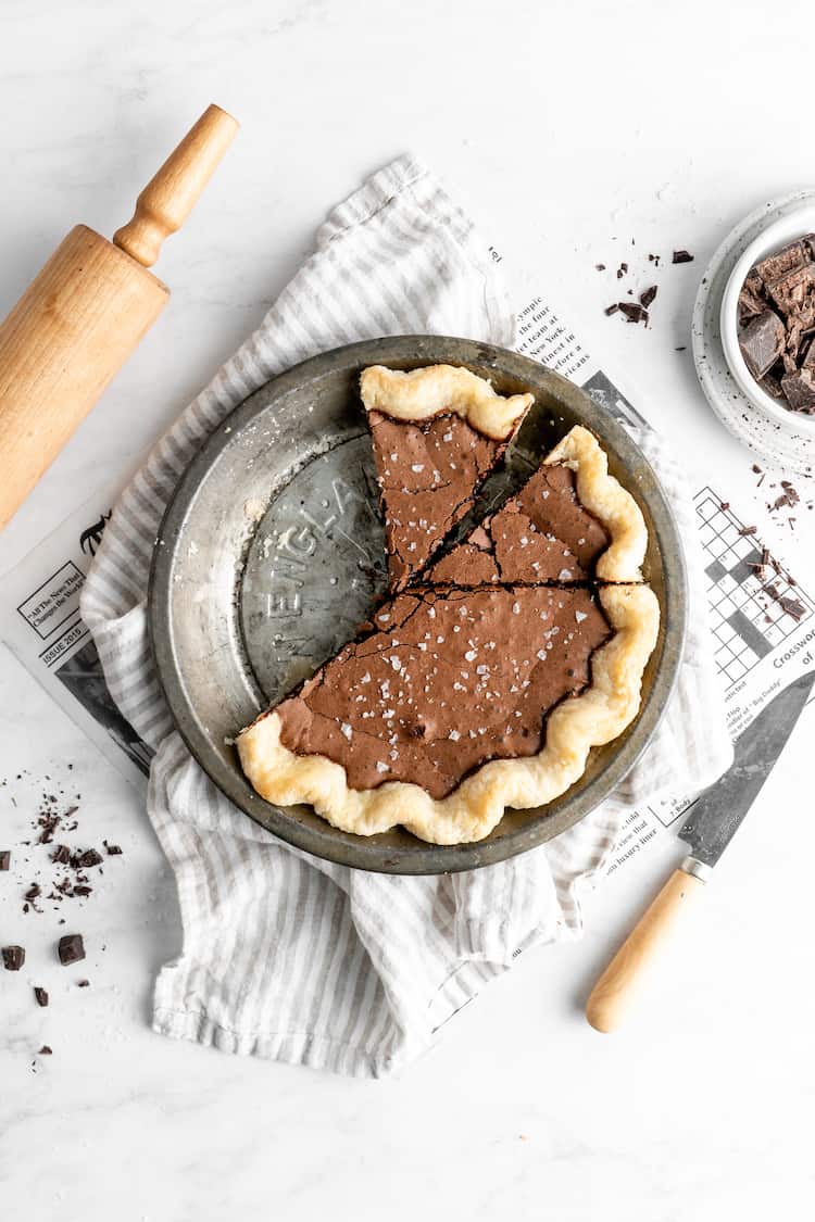 Slices cut from a chocolate chess pie against a white background