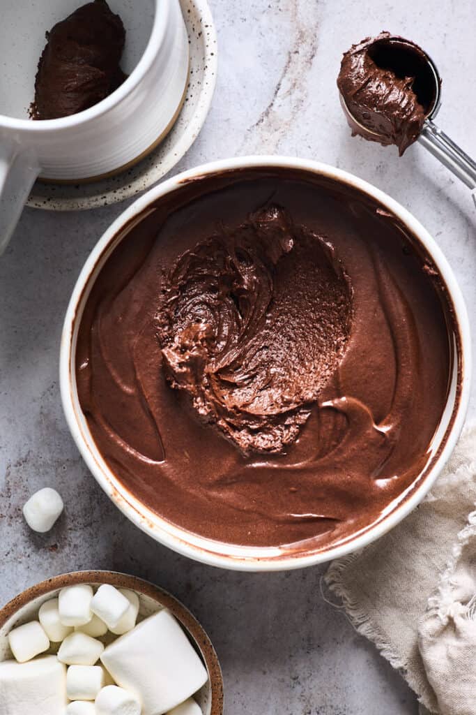 Thickened chocolate ganache with some scooped out to serve in mugs