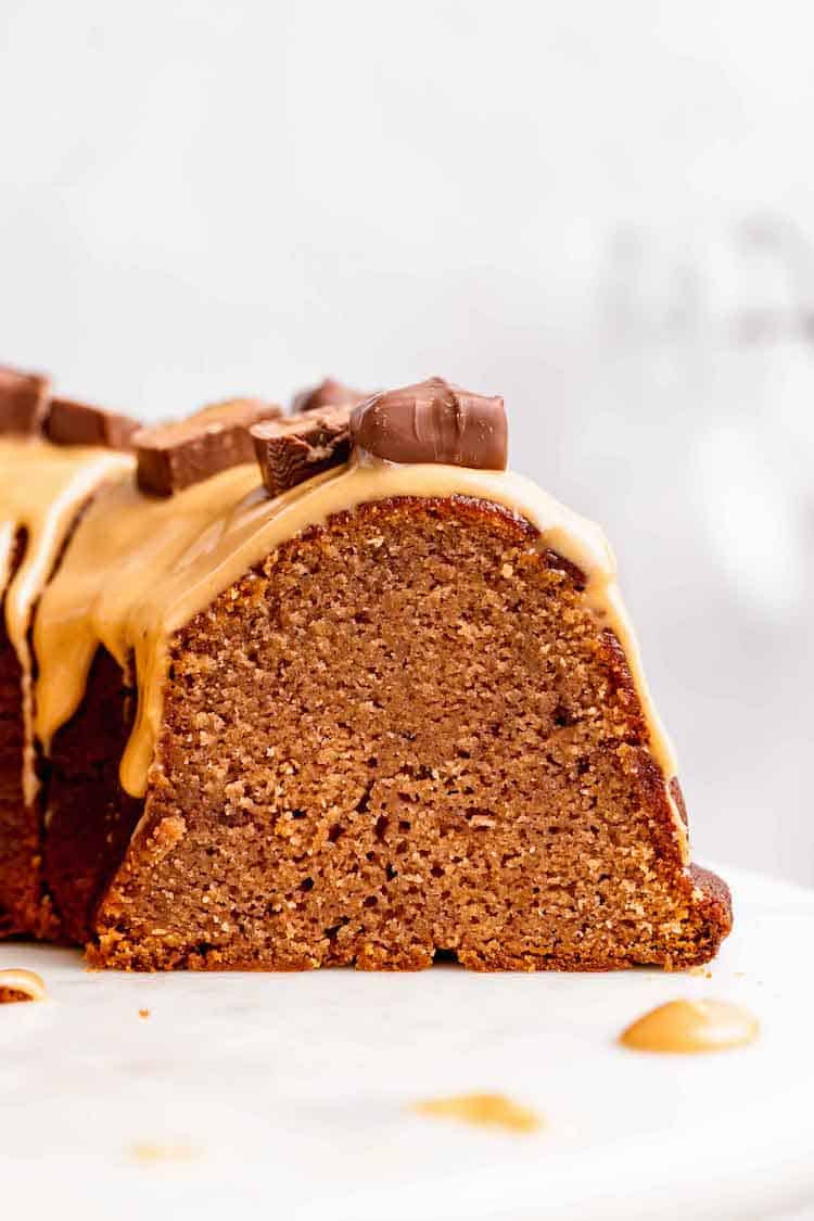 A close up of chocolate bundt cake with moist texture made with candy bars