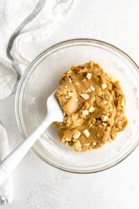 Blondie batter being combined with white chocolate chunks