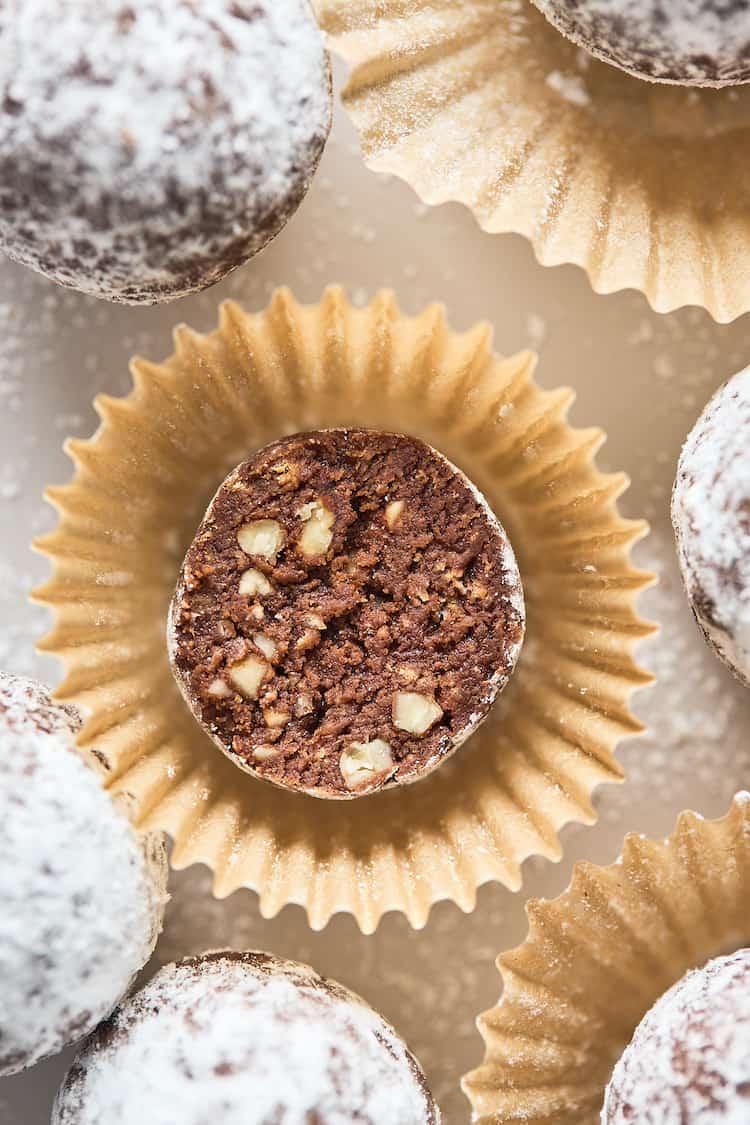 A close up of a bourbon chocolate ball cut in half