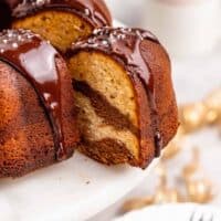 A slice of chocolate marble cake with sweet potato batter being pulled out after being cut